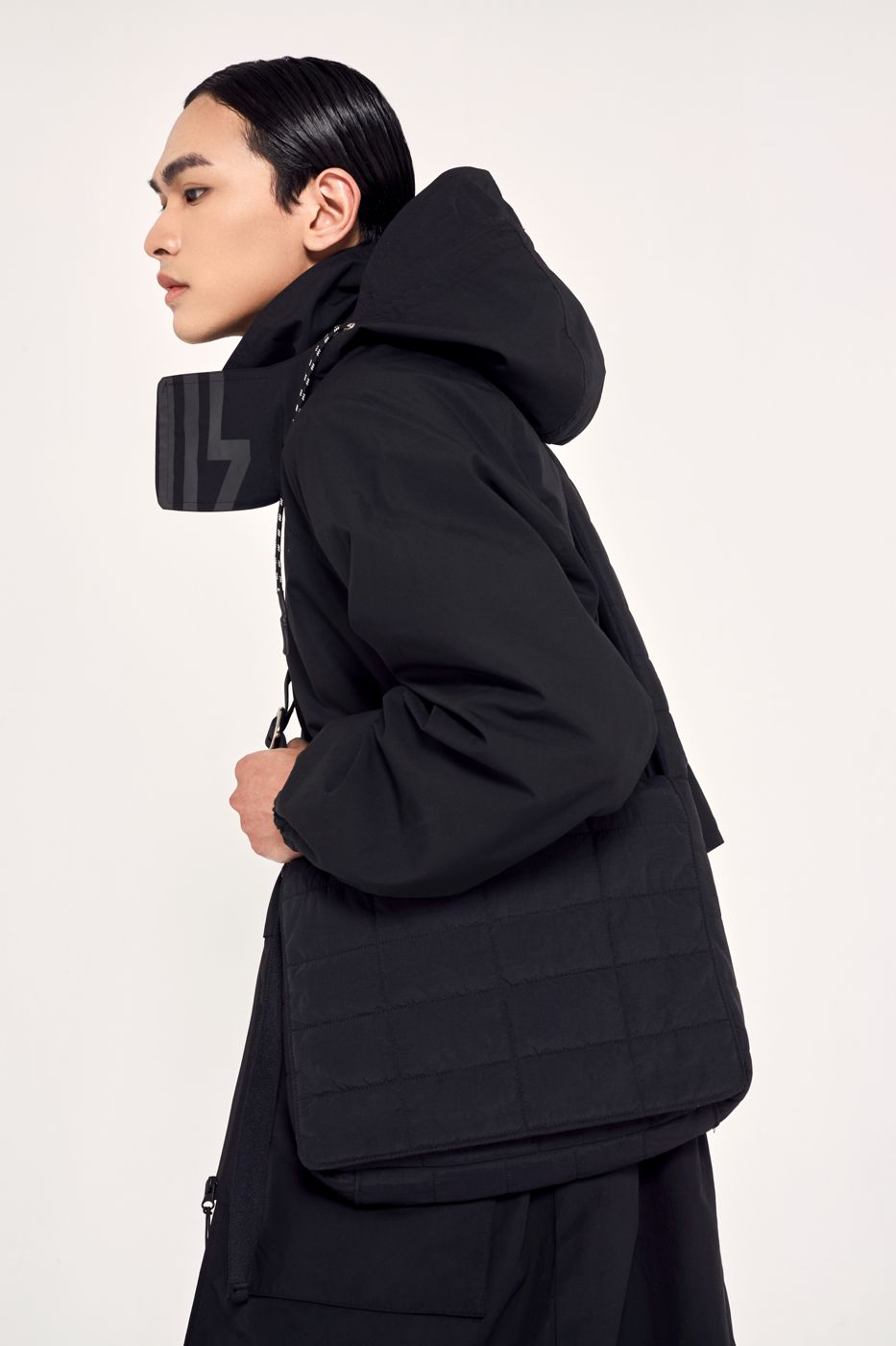Hood up, quilted bag, in profile