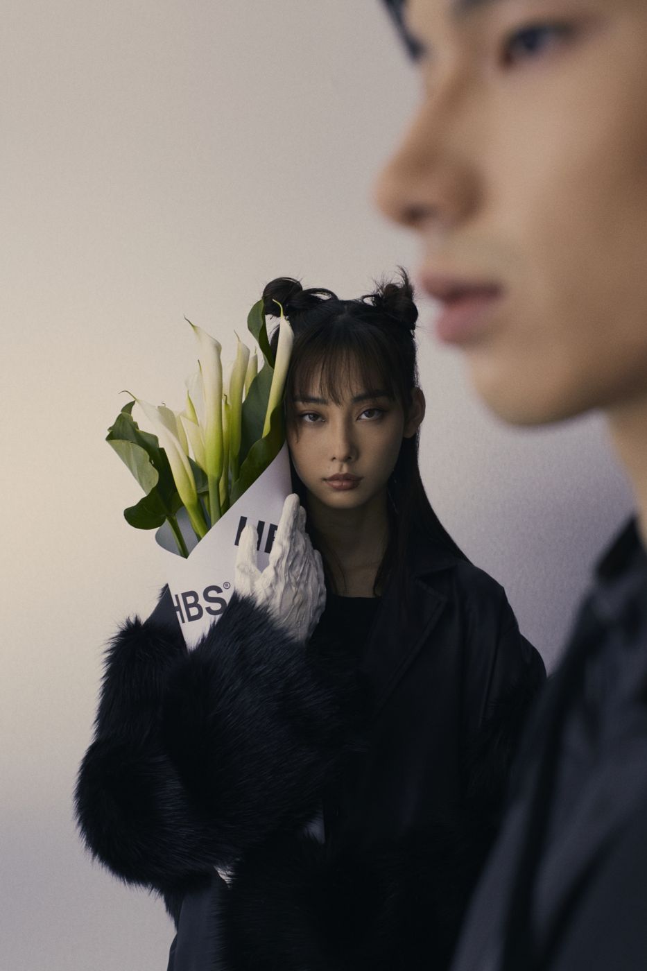 A profile in the foreground, lilies behind