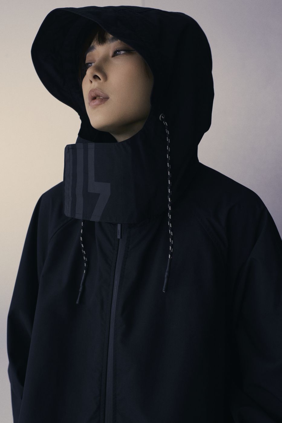 Face inside a wide black hood