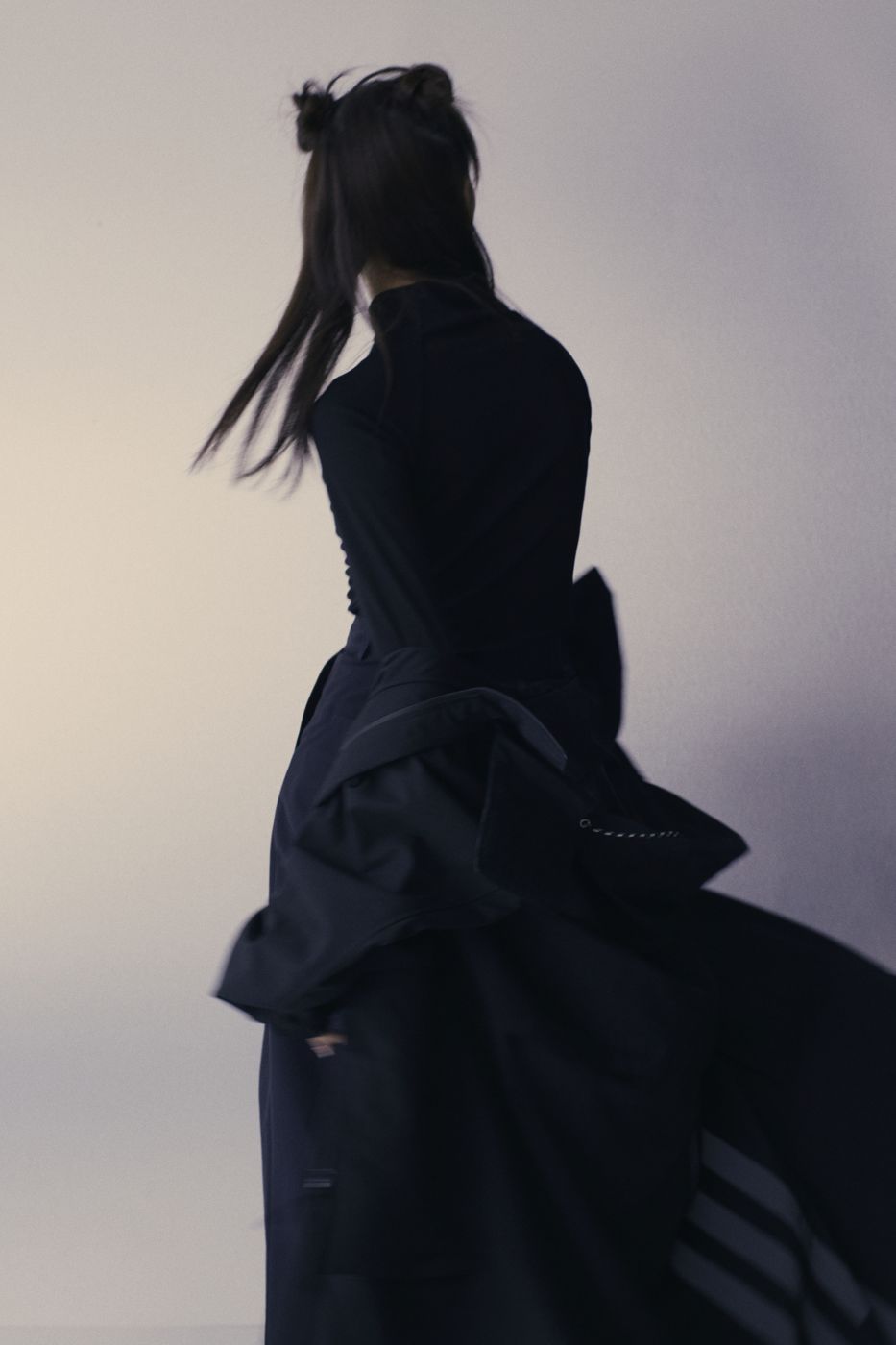 Hair caught mid-turn, black dress