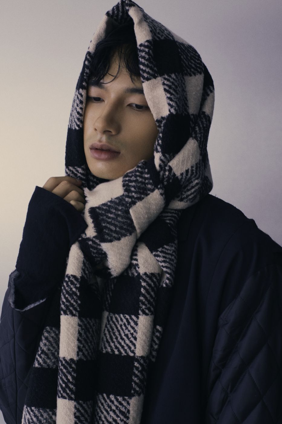 Checked scarf worn as a hood