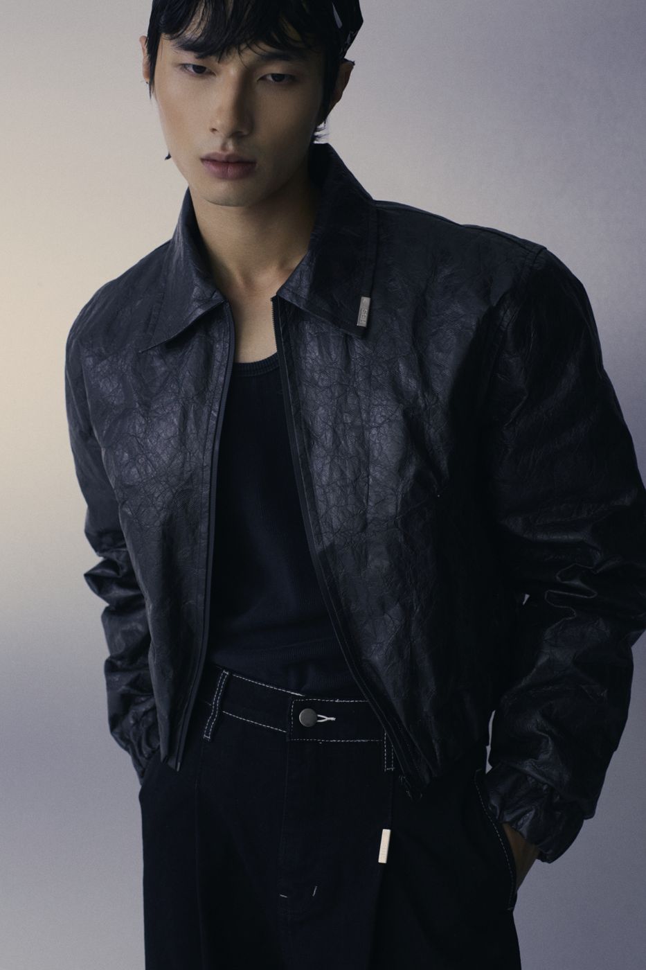 Creased leather jacket, eyes down